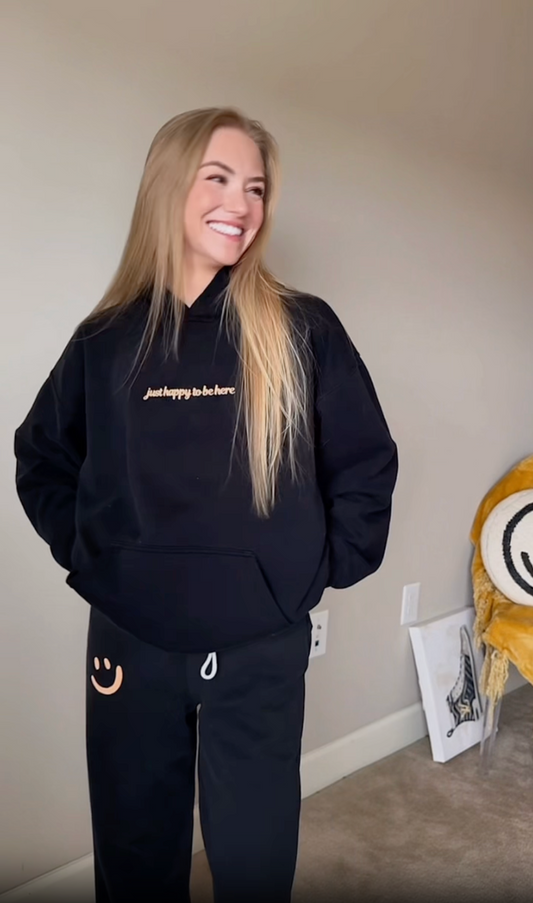 'just happy to be here' Hoodie in Black