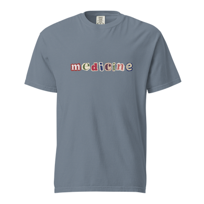 Gray t-shirt with 'medicine' printed in colorful letters on a white background