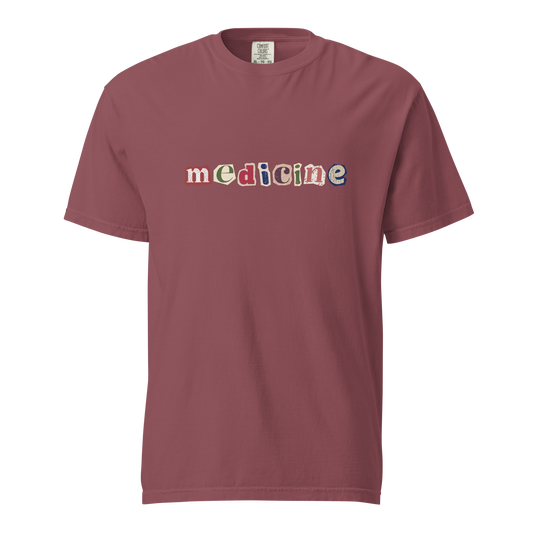 Maroon t-shirt with 'medicine' text in multicolor on a white background
