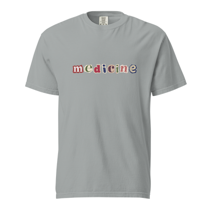 Gray t-shirt with 'medicine' in colorful letters on a white background